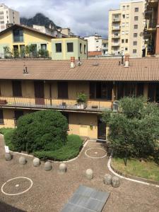 an apartment building with a courtyard and trees and buildings at Dany's house in Lecco