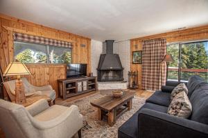 a living room with a couch and a fireplace at Goetzl By Hauserman Rentals in Tahoma