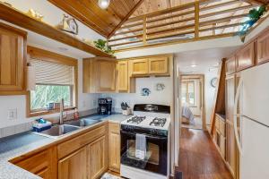 a kitchen with wooden cabinets and a stove at Whaleshead Getaway in Carpenterville