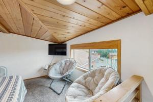 a room with two chairs and a desk and a window at Whaleshead Getaway in Carpenterville