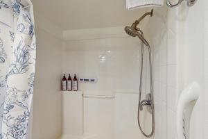 a bathroom with a shower with a shower curtain at Whaleshead Getaway in Carpenterville +12 photos