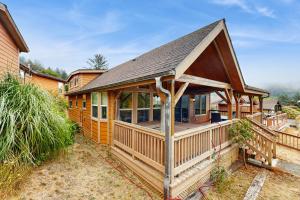 a large wooden house with a large deck at Whaleshead Getaway in Carpenterville