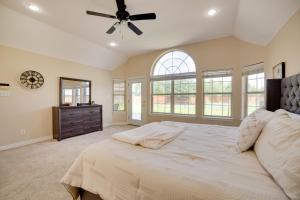 a bedroom with a large bed with a ceiling fan at Game Room and Bar Secluded Getaway in Farmersville in Nevada +26 photos