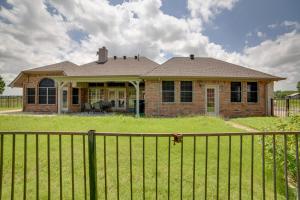 a brick house with a fence in front of it at Game Room and Bar Secluded Getaway in Farmersville in Nevada