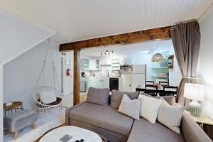 a living room with a couch and a dining room at West Ashley Abode in Charleston