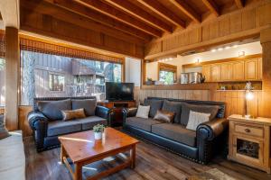 a living room with two couches and a tv at NorthShore # 47 By Hauserman Rentals in Tahoe City