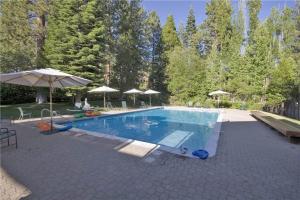 a large swimming pool with umbrellas on a patio at NorthShore # 47 By Hauserman Rentals in Tahoe City