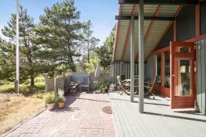 a porch of a house with a table and chairs at 1024-Thisted-Lars-Badskjaers-Sti-2 in Torsted