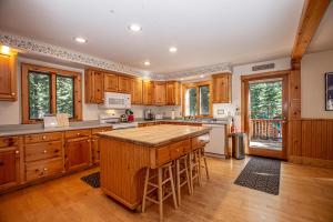 a large kitchen with wooden cabinets and a wooden island at Celtic Lodge By Hauserman Rentals in Homewood