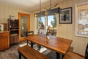 a dining room with a wooden table and a window at Catalpa Vista By Hauserman Rentals in Tahoe Vista