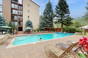 a pool at a hotel with a person swimming at Vail International #3 in Vail