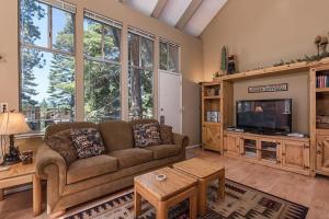 a living room with a couch and a tv at Dollar Hill II # 49 By Hauserman Rentals in Tahoe City
