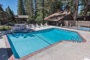 a swimming pool in a yard with chairs and a house at Dollar Hill II # 49 By Hauserman Rentals in Tahoe City