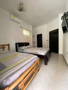 Ένα ή περισσότερα κρεβάτια σε δωμάτιο στο Habitacion Pauvemar en Coveñas
