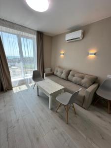 a living room with a couch and a table at Студия с Видом на Море, 9-2 in Chornomorsk +18 photos