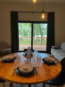 a wooden table with plates and glasses on top of it at Holiday House Nature in Lier