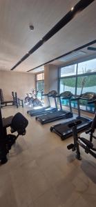 a gym with several treadmills and cardio machines at Studio Metrô Tatuapé Wi-fi-Piscina-Academia in Sao Paulo