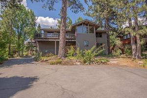 a large house with a porch and a driveway at Coates By Hauserman Rentals in Tahoe City