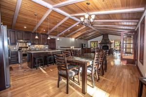 a kitchen with a wooden ceiling and a table and chairs at Highlands Lodge By Hauserman Rentals in Tahoe City