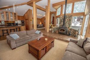 a living room with a couch and a fireplace at Snow Crest By Hauserman Rentals in Alpine Meadows