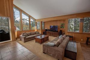 a living room with couches and a flat screen tv at Snow Crest By Hauserman Rentals in Alpine Meadows