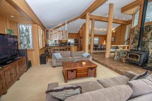 a living room with a couch and a tv and a fireplace at Snow Crest By Hauserman Rentals in Alpine Meadows