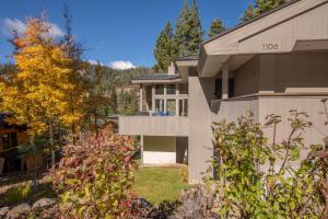 a house with a lot of trees in front of it at Snow Crest By Hauserman Rentals in Alpine Meadows