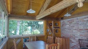 a dining room with a wooden table and chairs at Bozsoki Pihenő in Bozsok