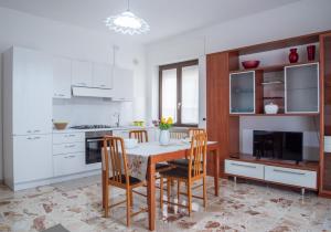 a kitchen with a table and chairs in a kitchen at Arborea Vita in Rotonda
