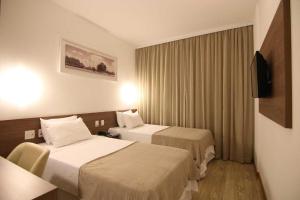 Postelja oz. postelje v sobi nastanitve Quarto duplo Samba Hotel Linhres