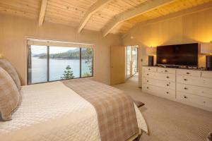 a bedroom with a large bed and a large window at McCown Lakefront By Hauserman Rentals in Tahoma