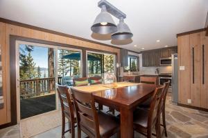 a kitchen and dining room with a wooden table and chairs at McKinney Cove By Hauserman Rentals in Homewood