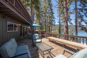 a deck with chairs and a table and an umbrella at McKinney Cove By Hauserman Rentals in Homewood