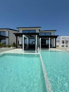 a house with a swimming pool in front of it at Villa La Vida in Kallithea Halkidikis