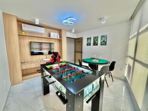a room with a ping pong table in the middle at DVA Cabedelo Beira-Mar – O Paraíso na Ponta de Cabedelo in Cabedelo +26 photos