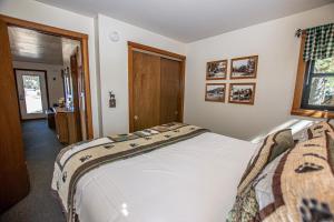 a bedroom with a large white bed in a room at Franciscan Lakeside # 29 By Hauserman Rentals in Tahoe Vista +16 photos