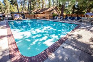 a swimming pool with blue water in a yard at Franciscan Lakeside # 29 By Hauserman Rentals in Tahoe Vista
