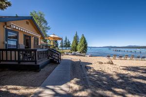 a house on the shore of a beach at Franciscan Lakeside # 29 By Hauserman Rentals in Tahoe Vista