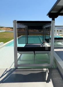 a bed on the roof of a house with a pool at Villa La Vida in Kallithea Halkidikis +46 photos