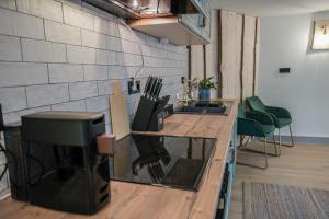a kitchen with a sink and a counter top at Alpino STAY Geräumige Ferienwohnung am Alpsee mit Garten in Immenstadt im Allgäu +15 photos