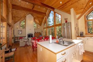 a kitchen and dining room of a log home at Snowglobe By Hauserman Rentals in Tahoe City