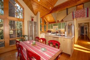 a kitchen with a table and chairs in a house at Snowglobe By Hauserman Rentals in Tahoe City +14 photos