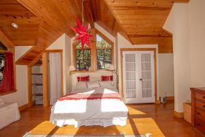 a bedroom with a bed in a room with wooden ceilings at Snowglobe By Hauserman Rentals in Tahoe City