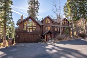 a large wooden house with a wooden garage at Snowglobe By Hauserman Rentals in Tahoe City