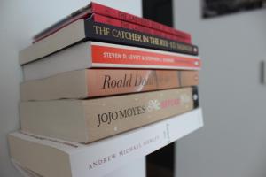 a stack of books sitting on top of each other at The Tilman in Barmouth