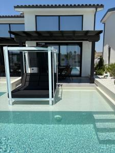a house with a swimming pool in front of a house at Villa La Vida in Kallithea Halkidikis