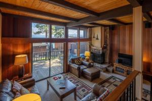 a living room filled with furniture and a large window at Star Harbor # 4 By Hauserman Rentals in Tahoe City