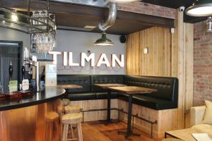 a restaurant with a black bench and a bar at The Tilman in Barmouth