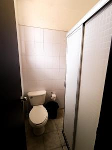 a small bathroom with a toilet in a stall at Descanso en el corazón de Gdl in Guadalajara