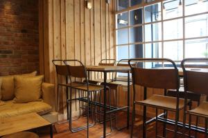 a restaurant with chairs and a table and a couch at The Tilman in Barmouth